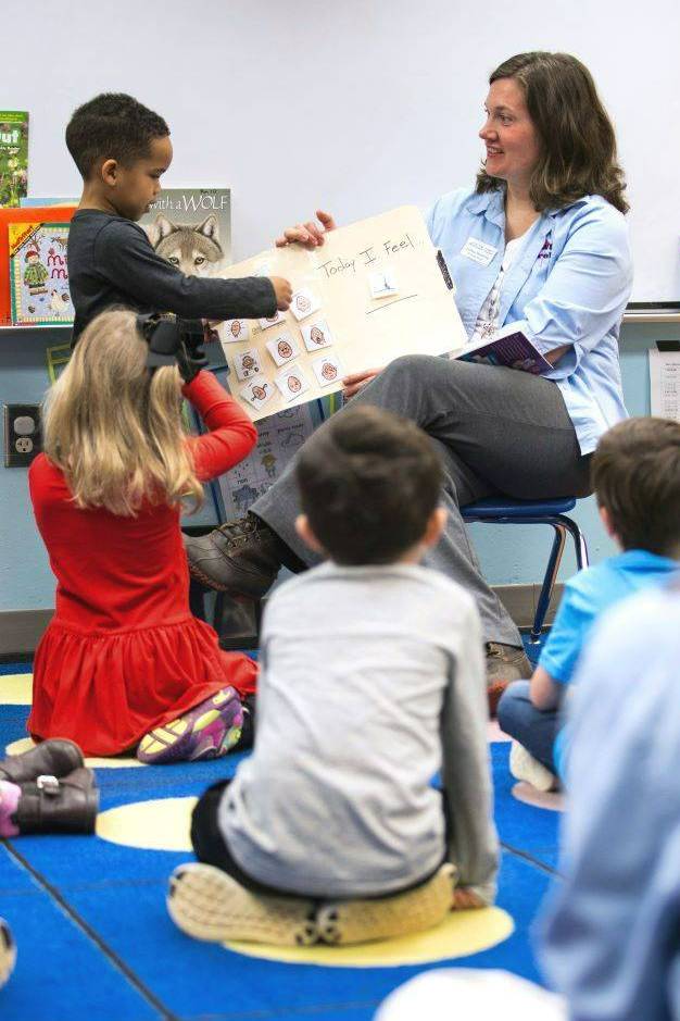Teacher reading to an elementary school class