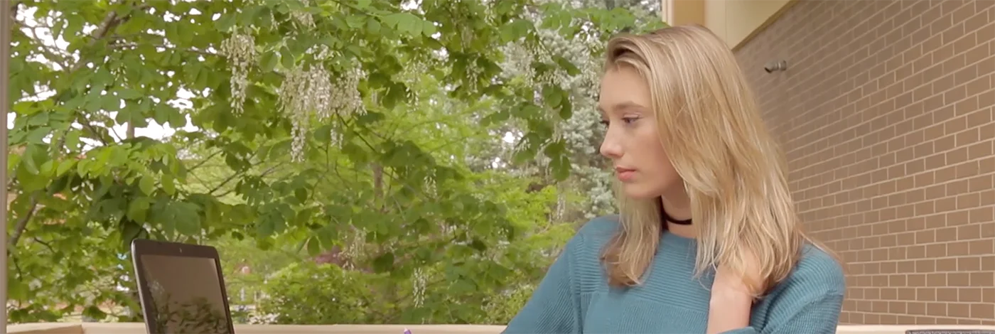 Student on campu sitting at table