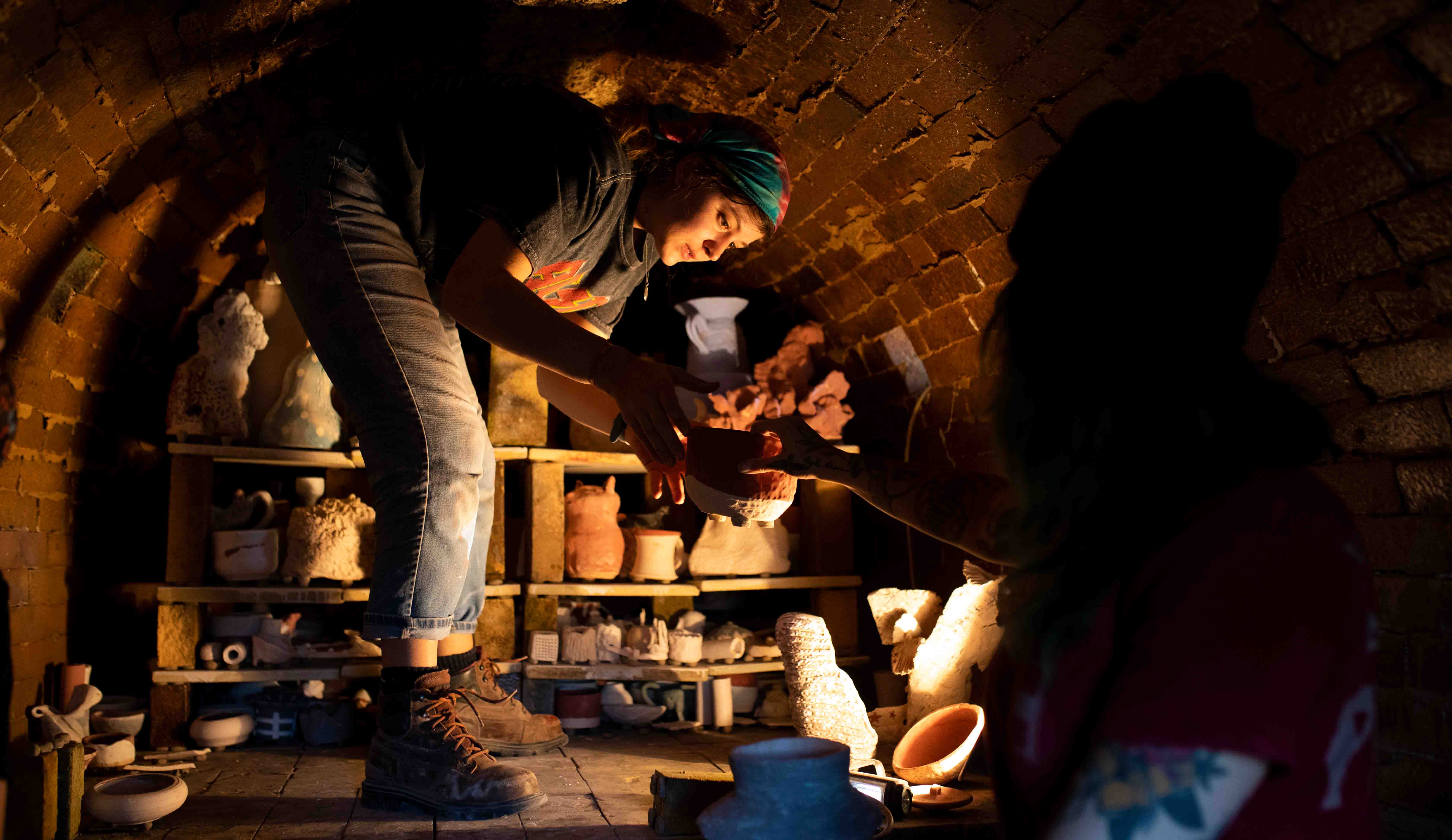 Students load the Anagama Kiln outside the Visual Arts Building