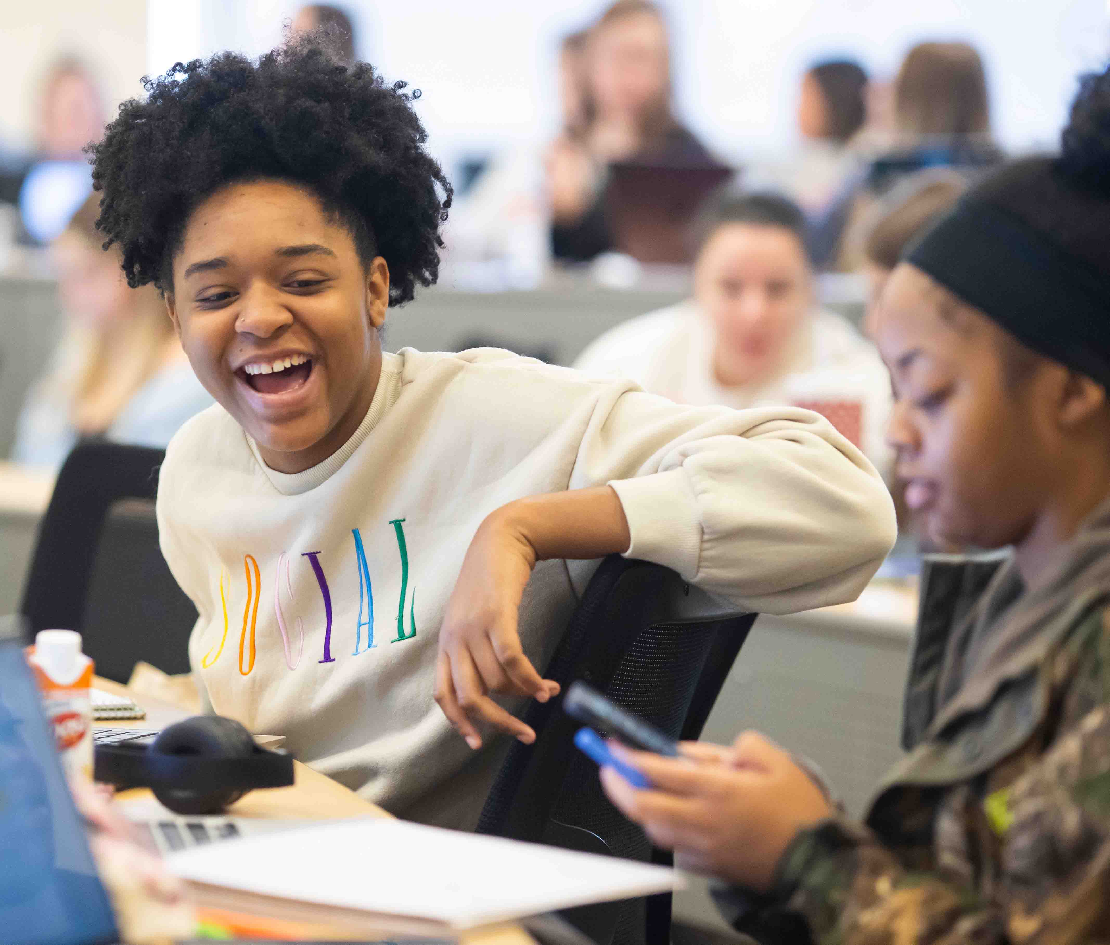 Two students talking in class