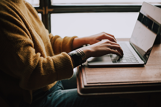 girl typing on laptop