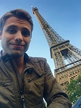 Ethan Brown in Paris next to the Eiffel Tower