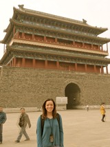 Maria Escuela next to a temple in China