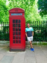 Zebb Ott next to a red phone booth in London