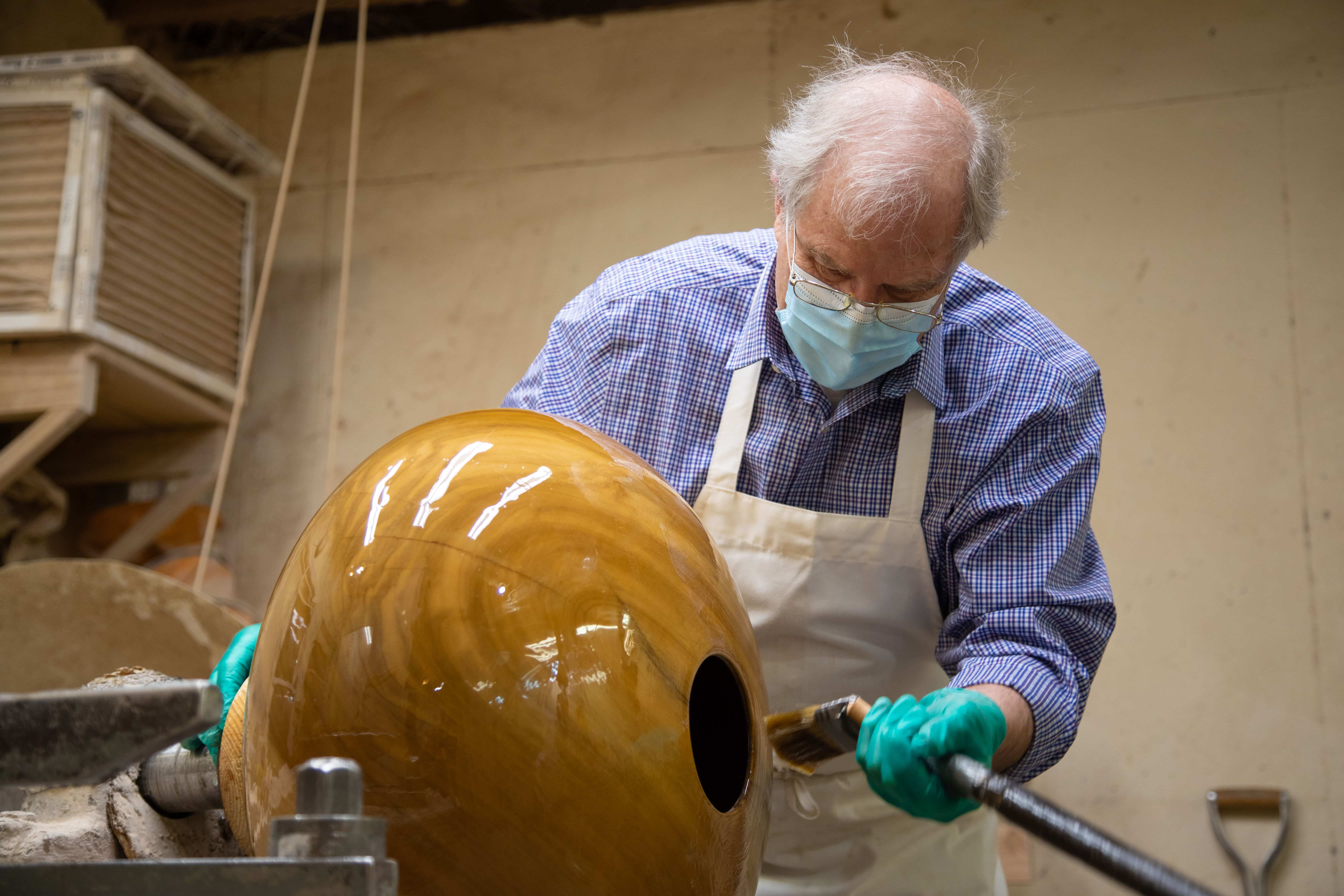 Philip Moultrop polishes the bowl he carved for Richards College of Business.