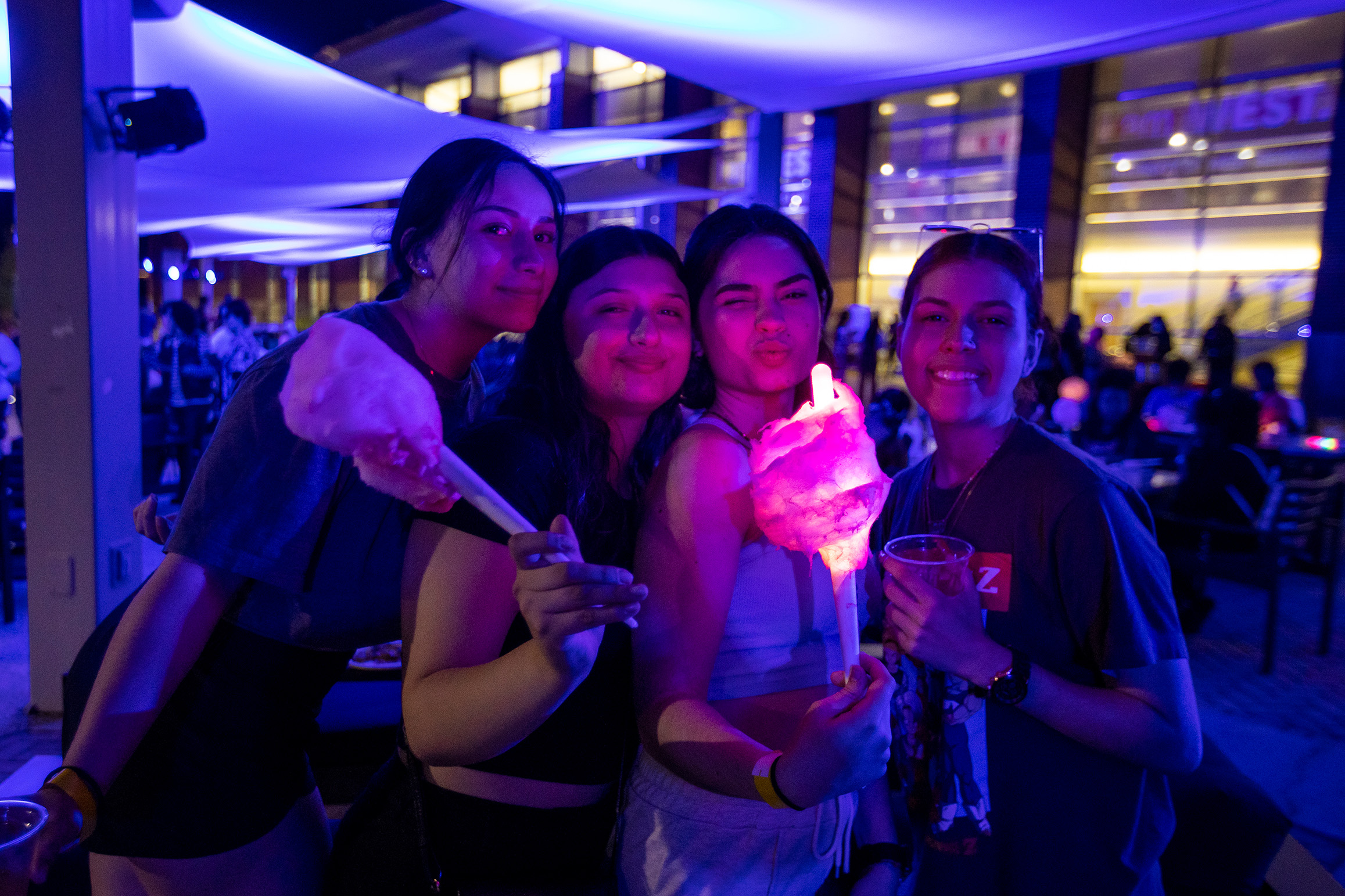 Students eating cotton candy at an event