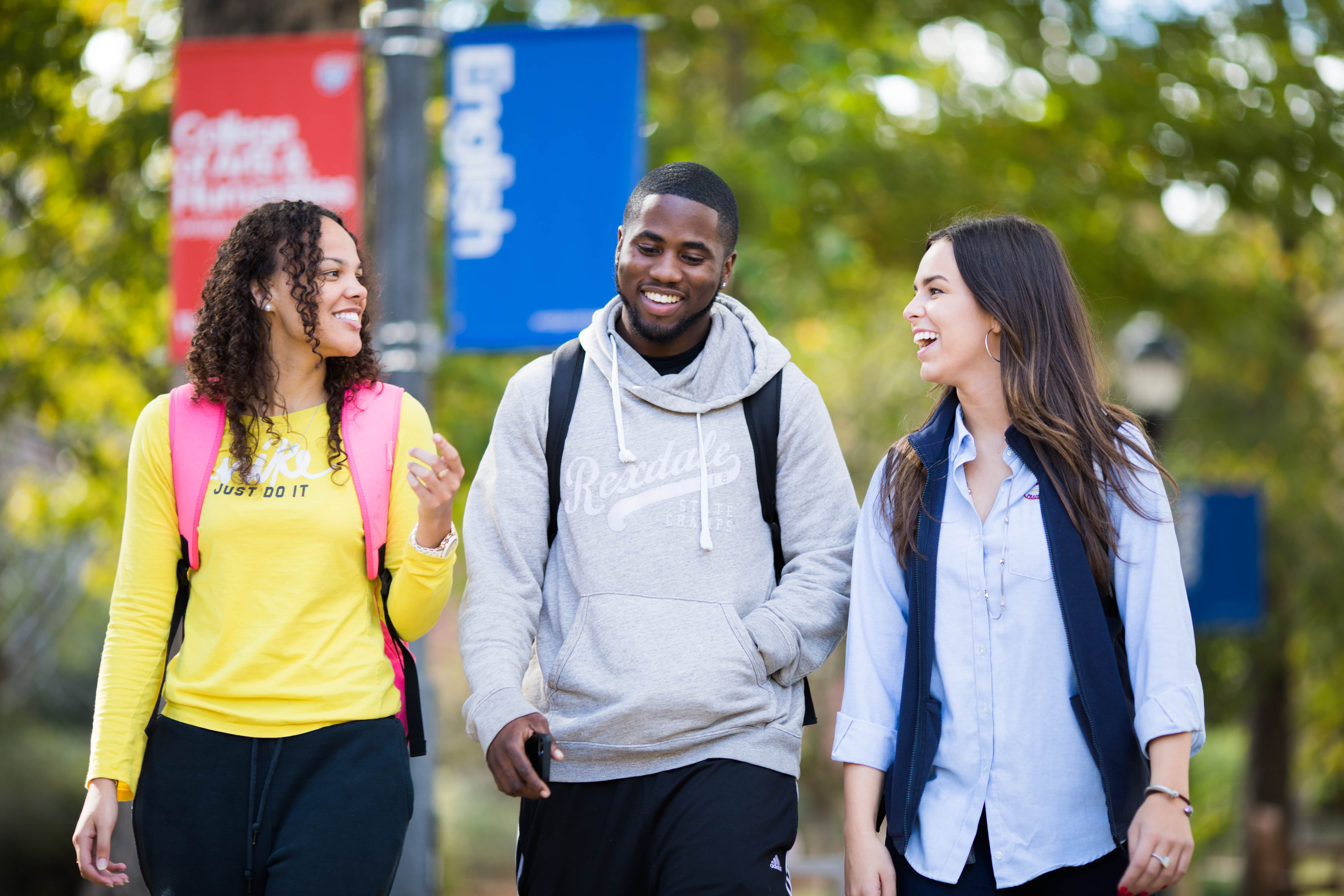 Three students walking through campus.