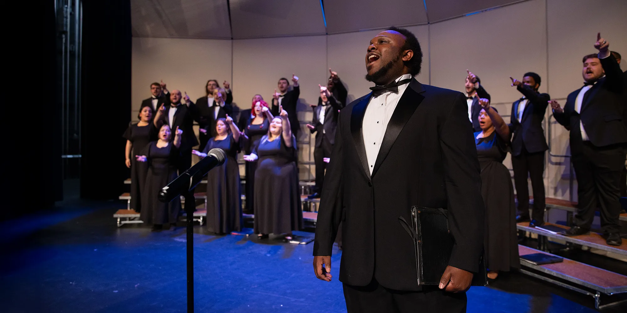 choir singing with lead singer in forground