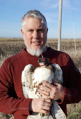 Dean Bickford holding a bird of prey
