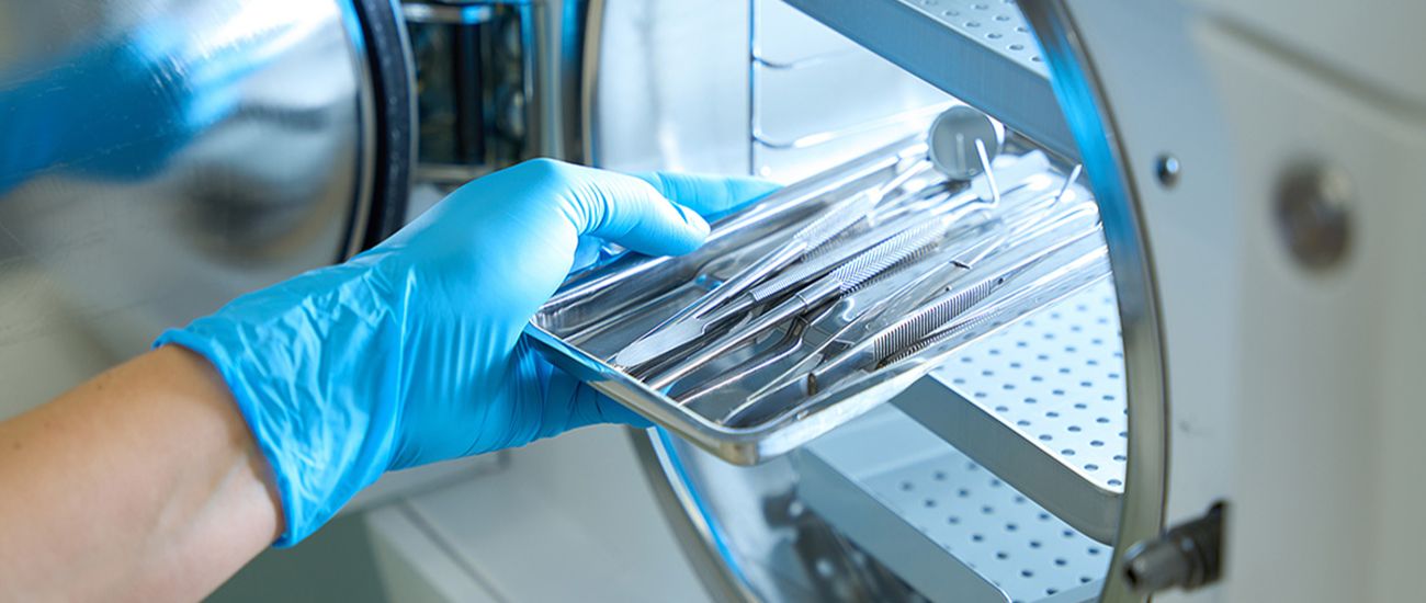 Healthcare worker sterilizing tools