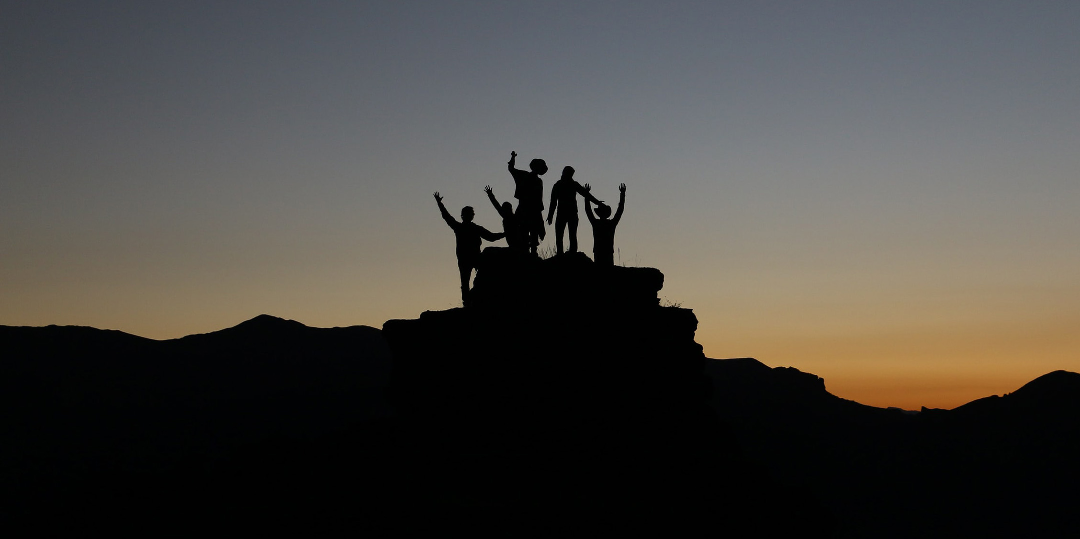 Students on a hill at sunset