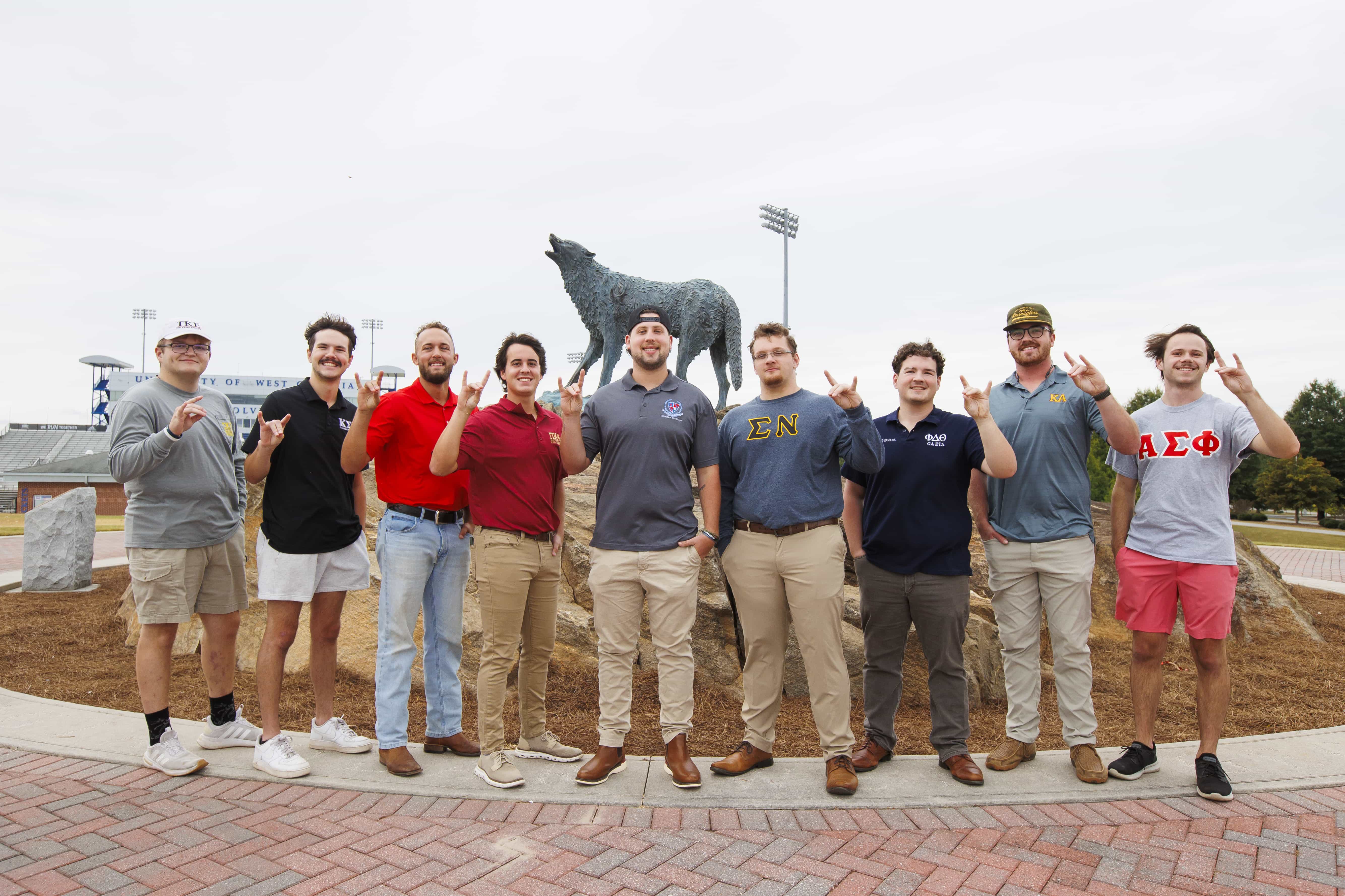 IFC members in a single line at wolf statue