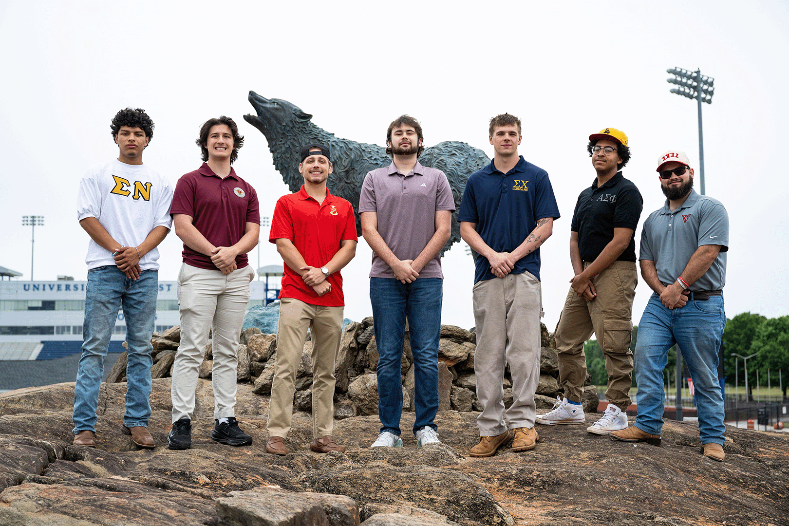 IFC members in a single line at wolf statue