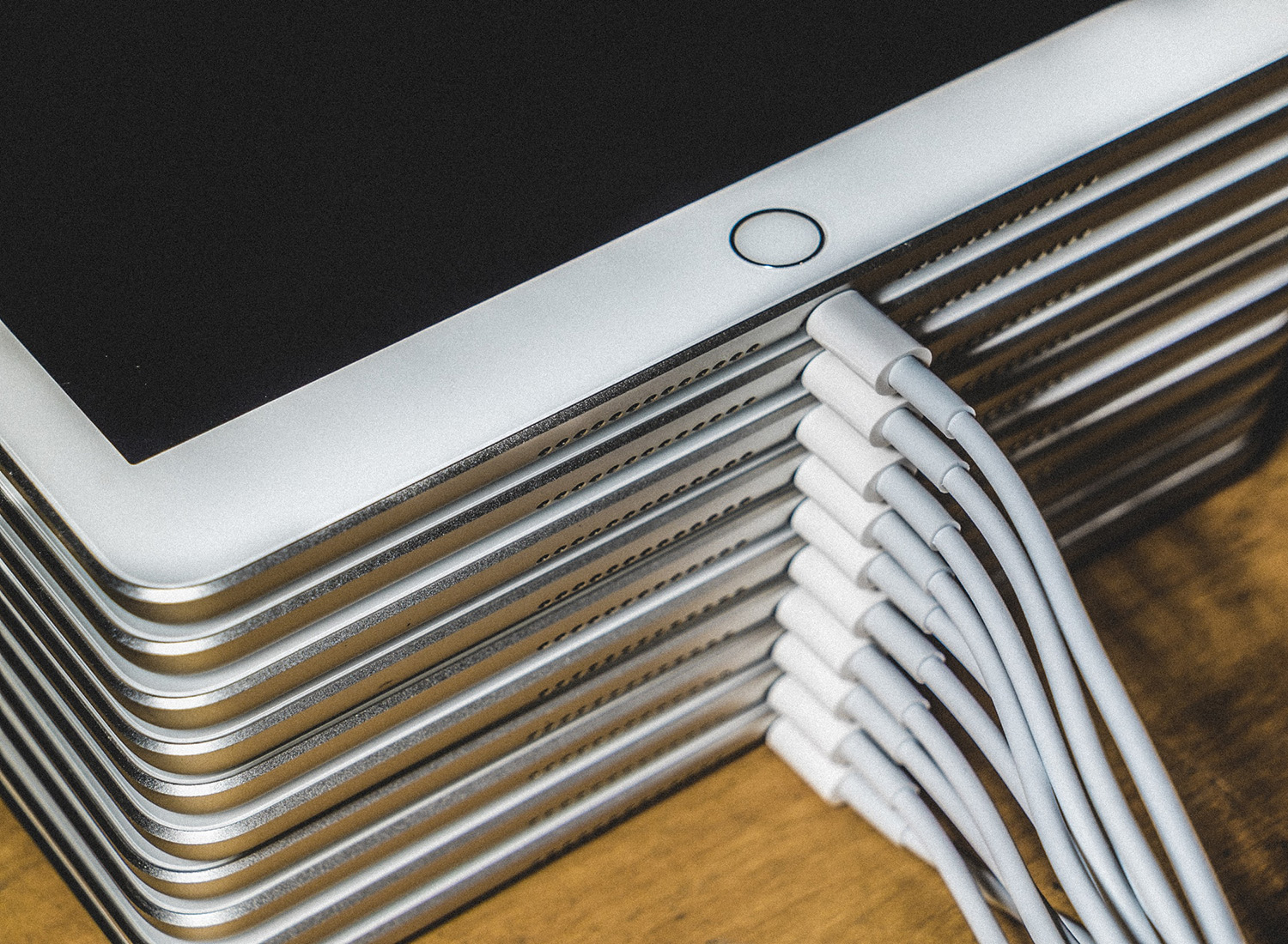 stack of white ipads charging
