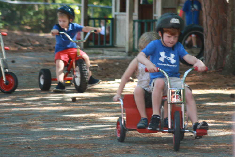Pre-K students riding tricycles