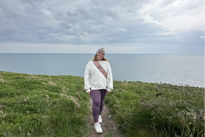 woman standing in a field posing for the camera