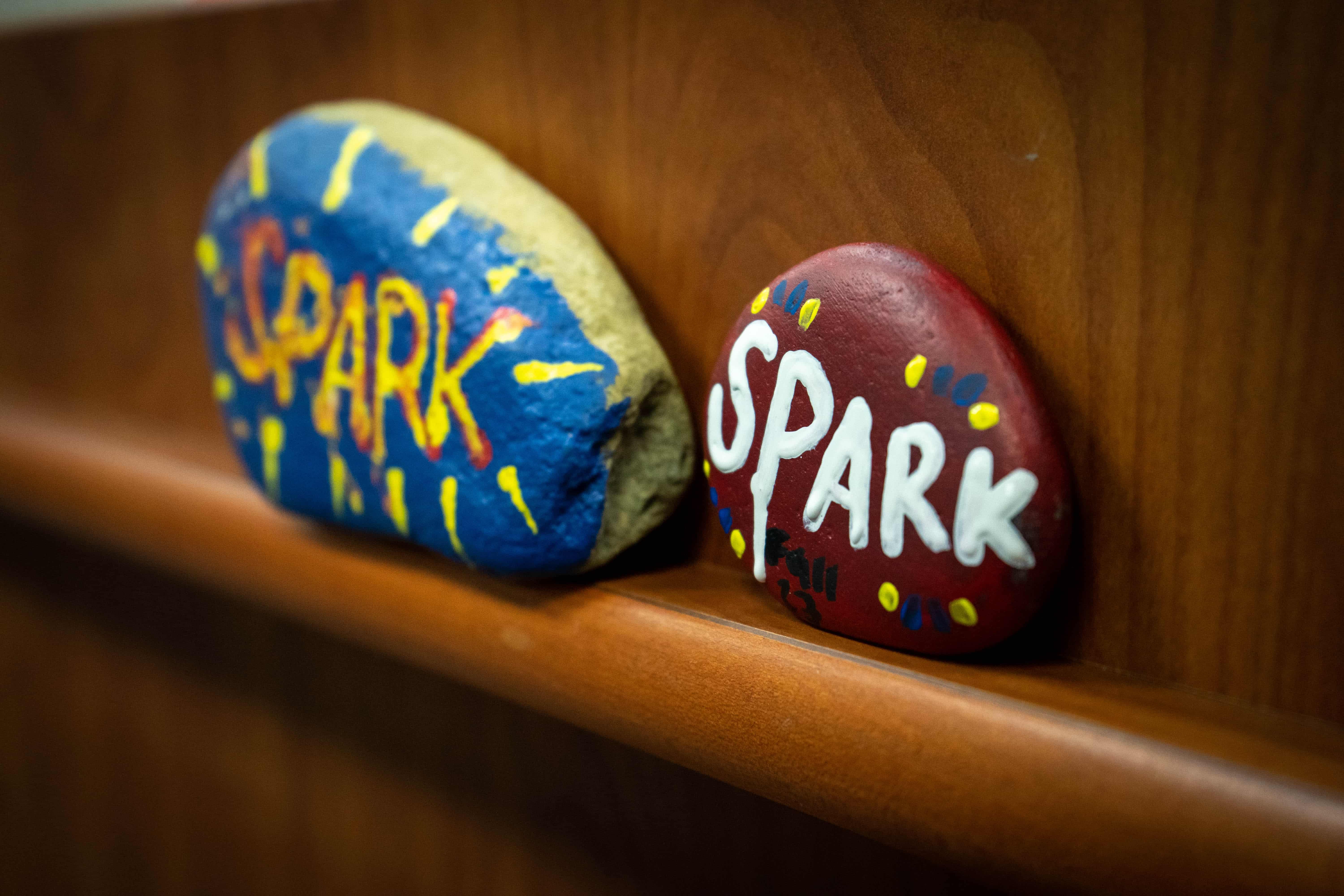 Rocks painted with the name Spark on them.