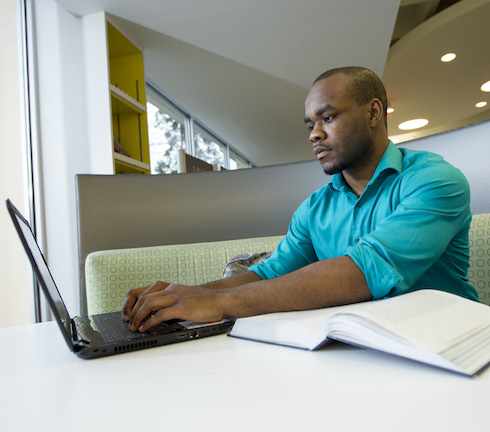 man sitting at computer