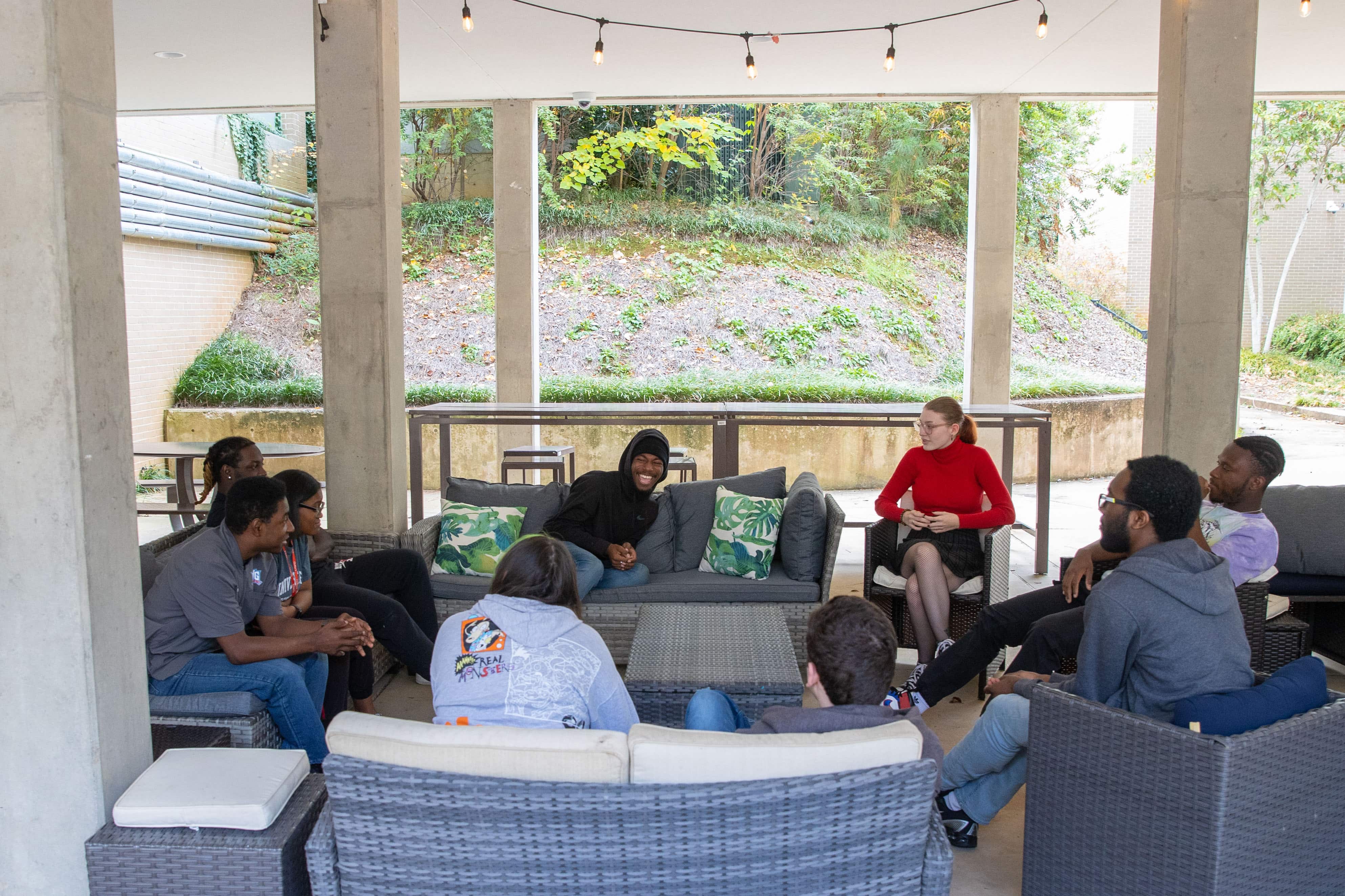Group of students sitting in Bowdon Hall's outdoor seating area.
