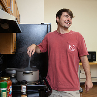 Student cooking a meal in the dorm. 