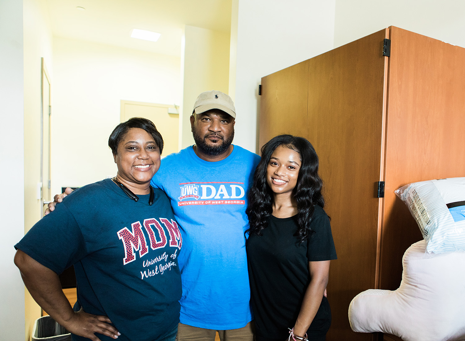 Family with their student in a residence hall room