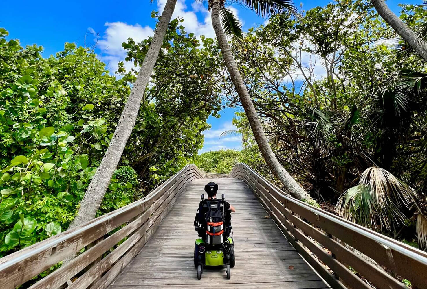 UWG alumnus Cory Woodard in his wheelchair going toward the beach