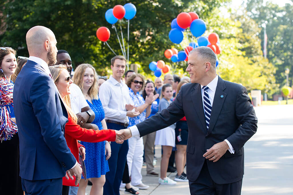 Crowds gather on Front Campus to welcome the Johnsons