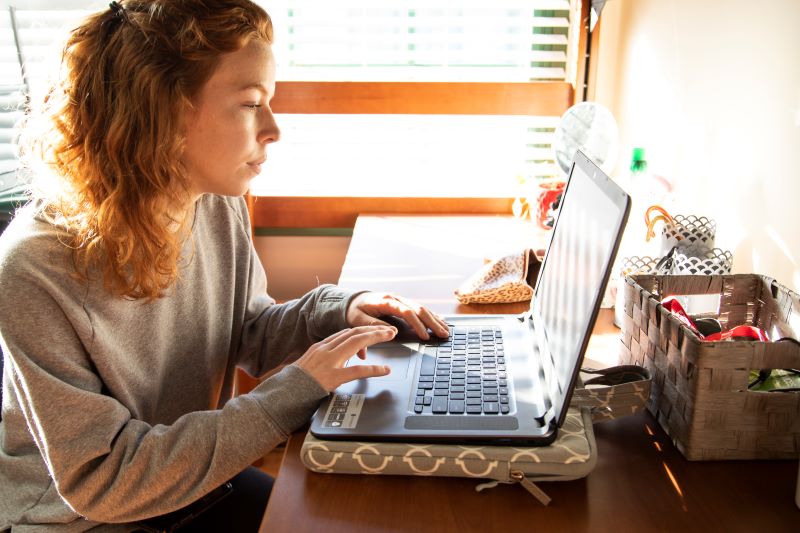UWG online student working on a laptop