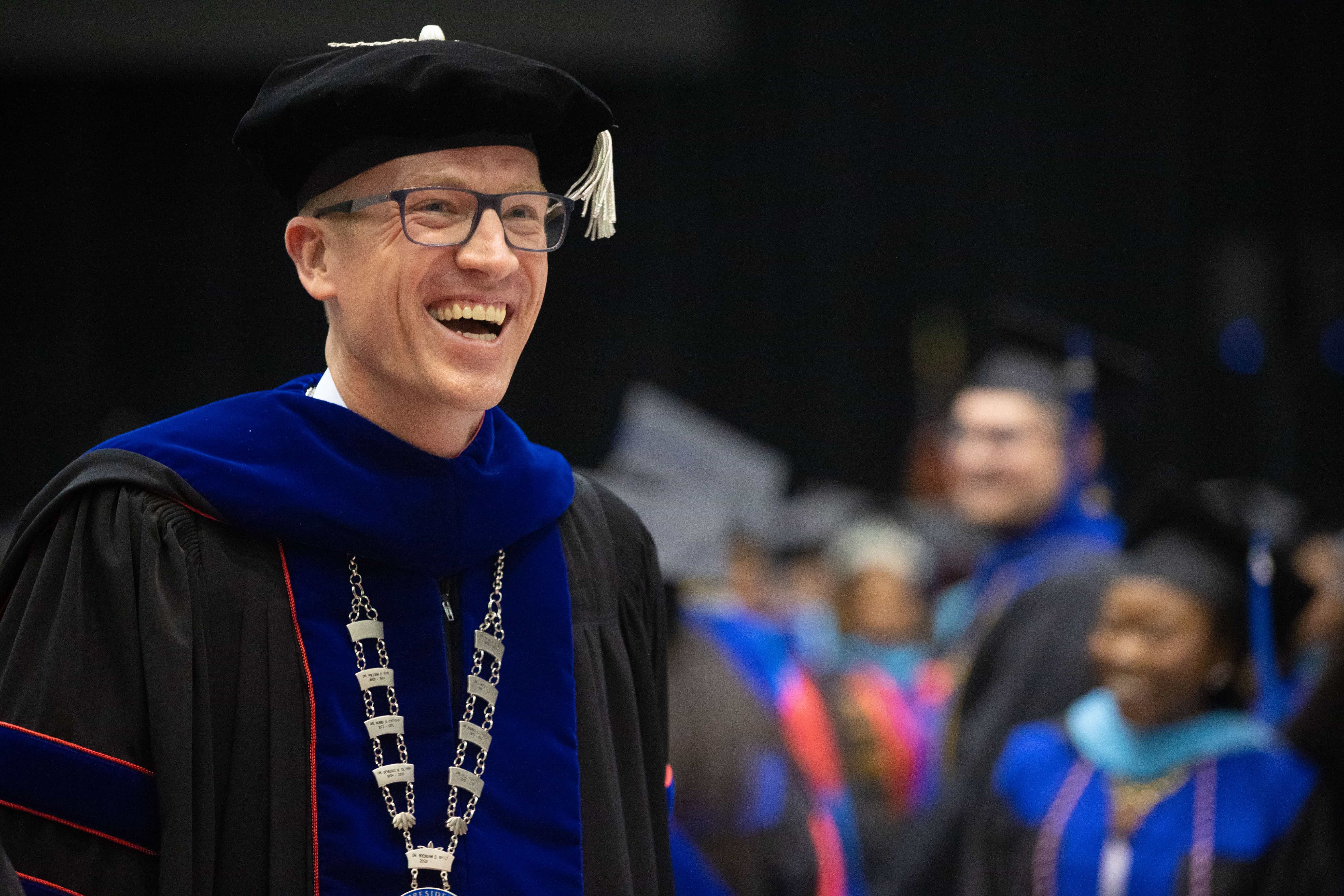 Dr. Kelly smiling at Commencement.