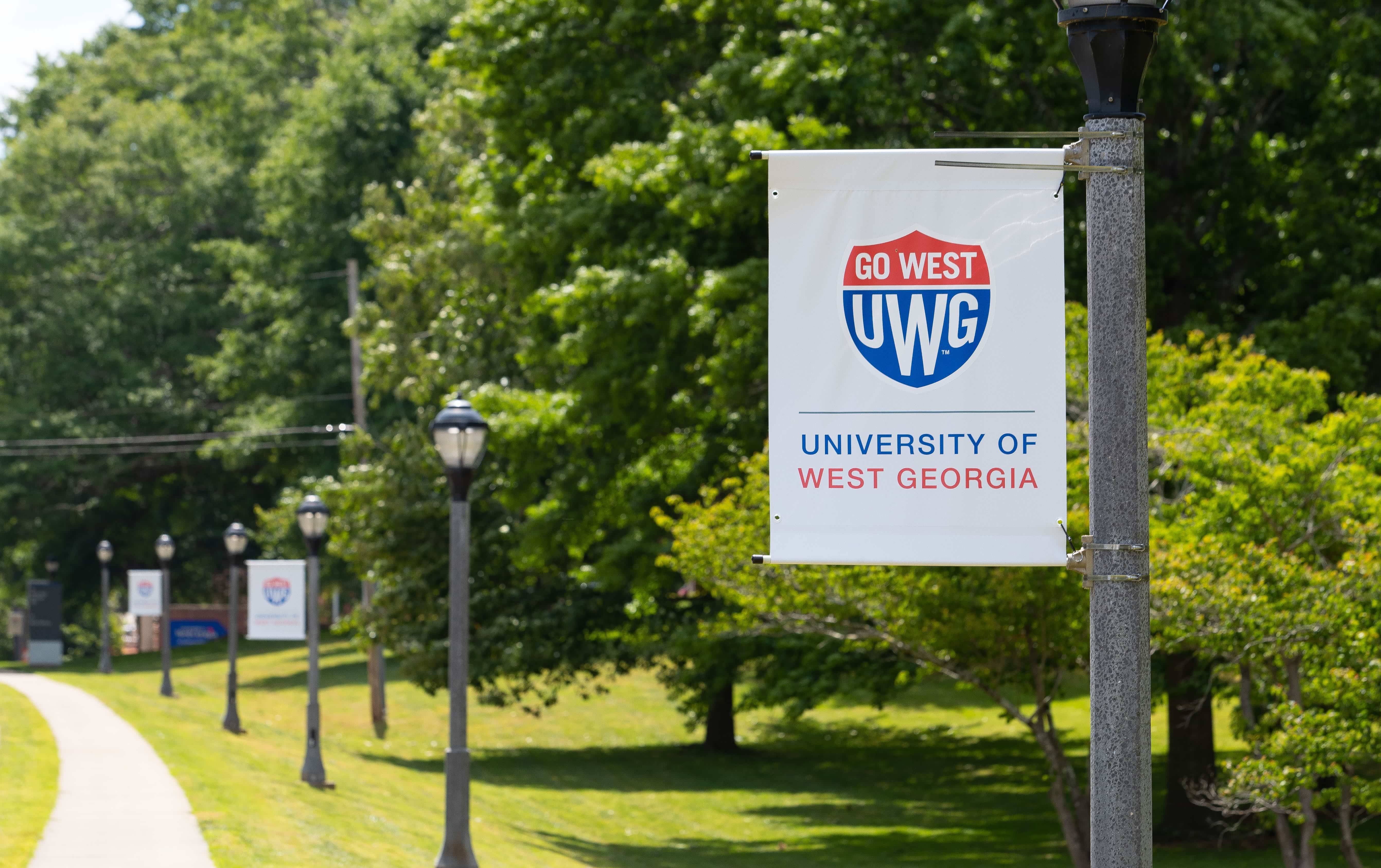 UWG Campus featuring white sign with the UWG shield prominently displayed.