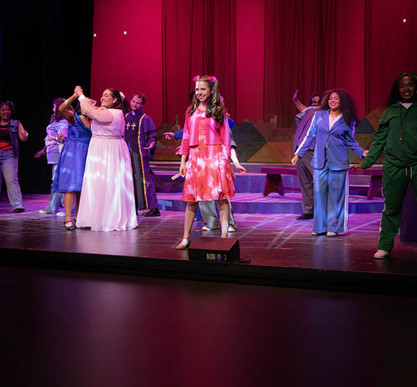 students performing on stage