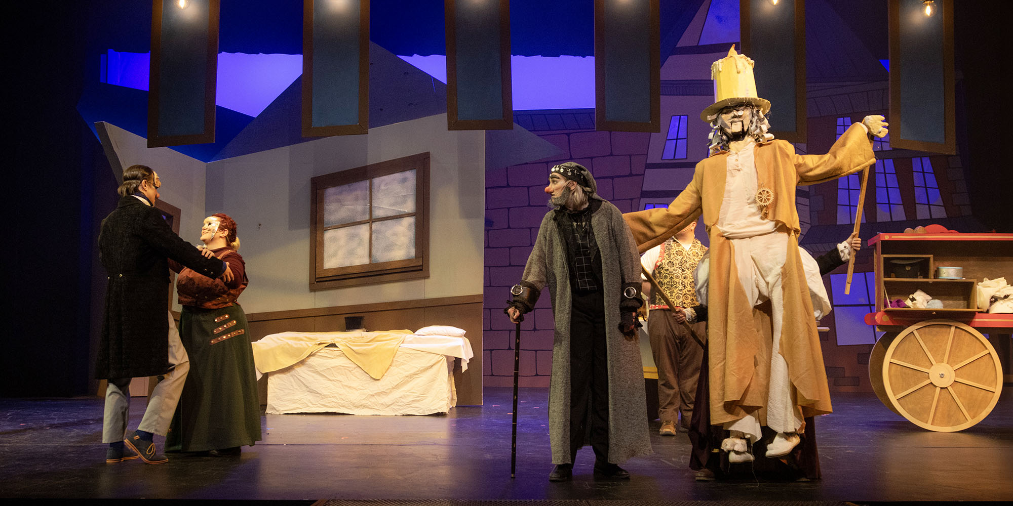 production of Tiny Tim's Christmas Carol with Scrooge and other characters on stage