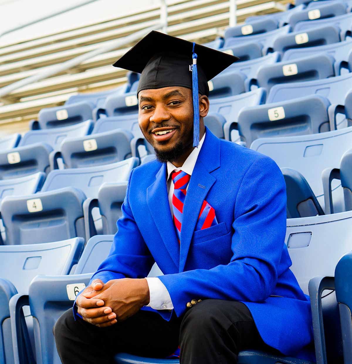 Image of D'angelo Hughes in his Blue Coat blazer and cap