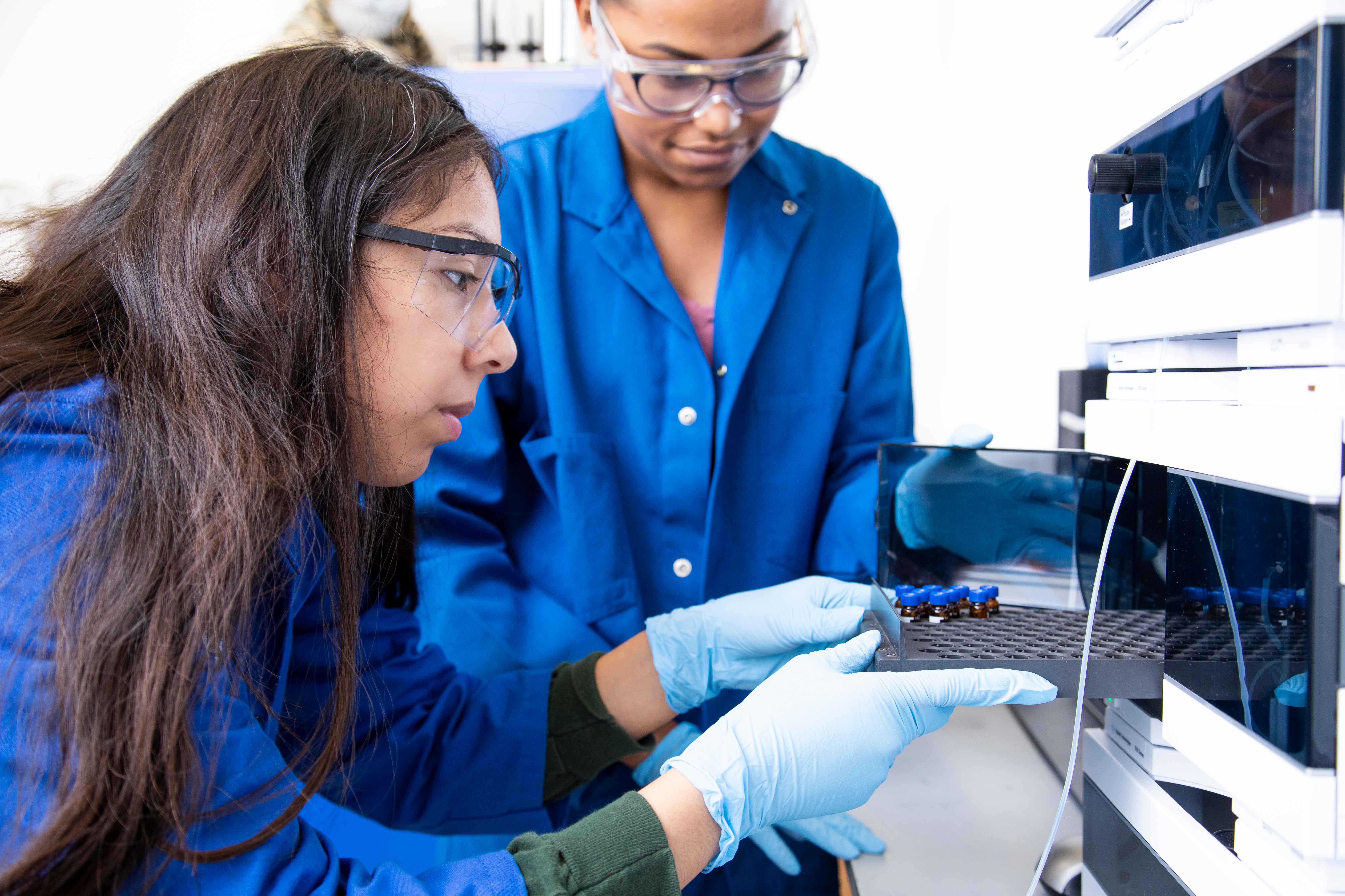 Two students working on a chemistry experiment