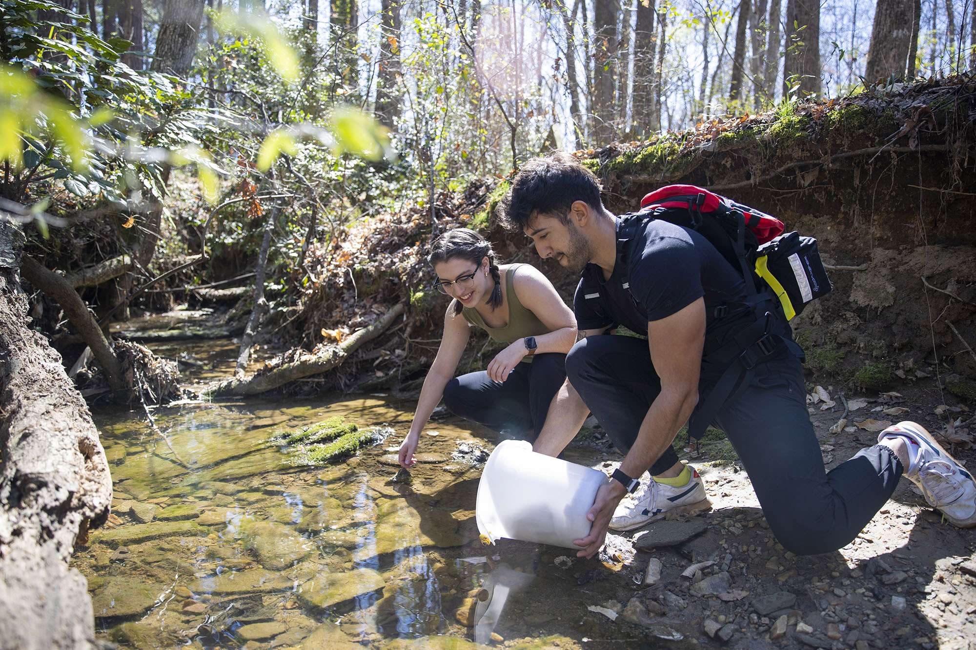 Students working in a creek