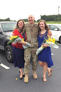 Photo of University of West Georgia employee and alumnus Jim Martin with his wife and daughter