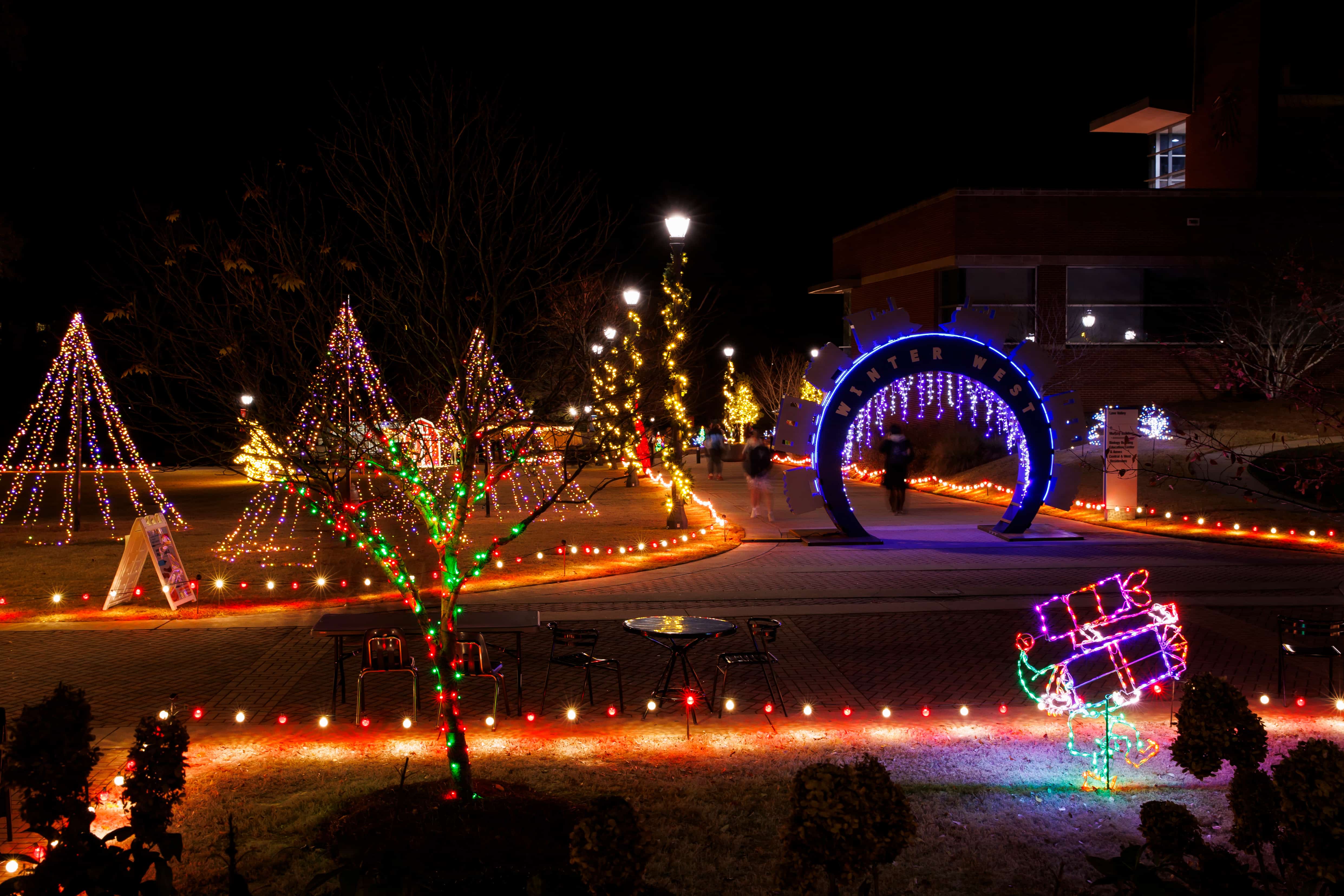 Winter West Wonderland at night, showing the campus center and various light sculptures in the background.