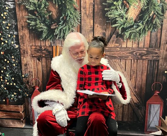Santa Claus and child with book
